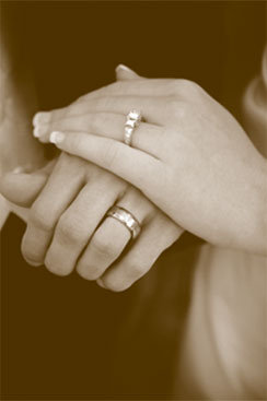 hands wearing wedding rings